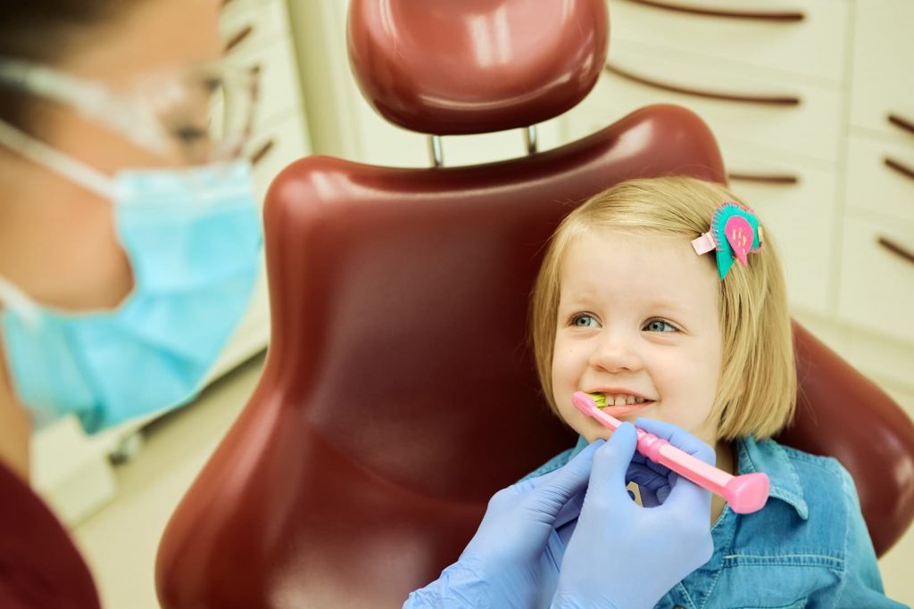 Little girl sitting in a dental chair